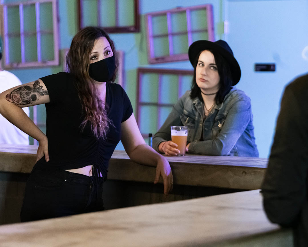 Kara the bartender (Casey Winn) and her patron (Jess Brasseaux) throw some shade.